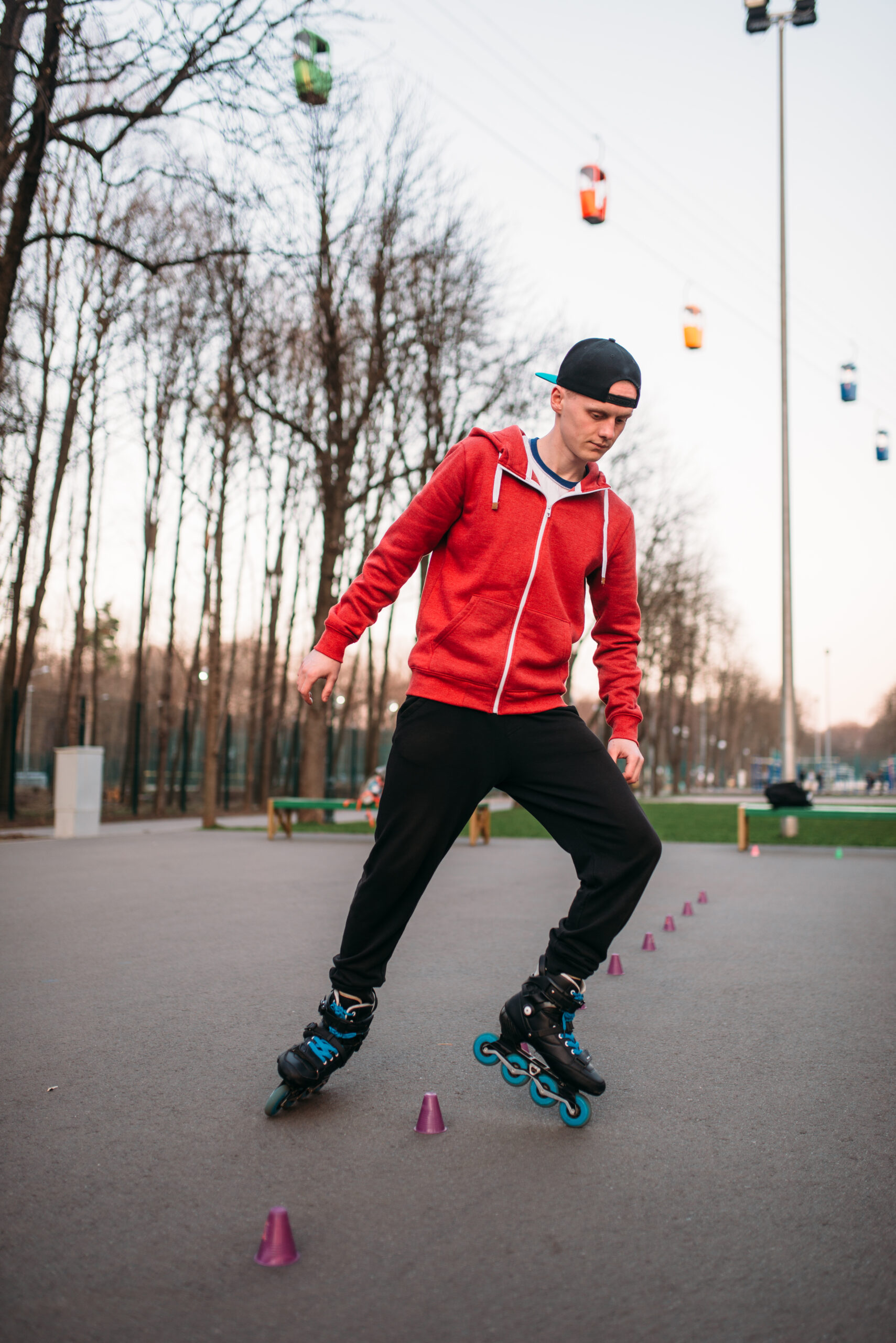 Roller skater legs in skates on asphalt walkway in city park. Male rollerskater leisure